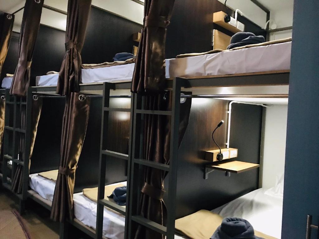 a group of bunk beds in a room at Sleep cafe hidee247 in Pratunam
