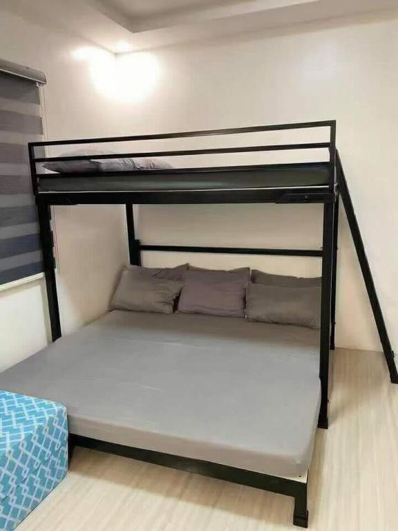 a bunk bed in a small room with a bunk bed at A&E Transient Rooms in Calatagan