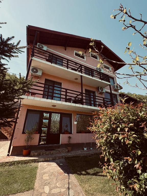 a large house with a balcony on top of it at Casa Darian in Dubova
