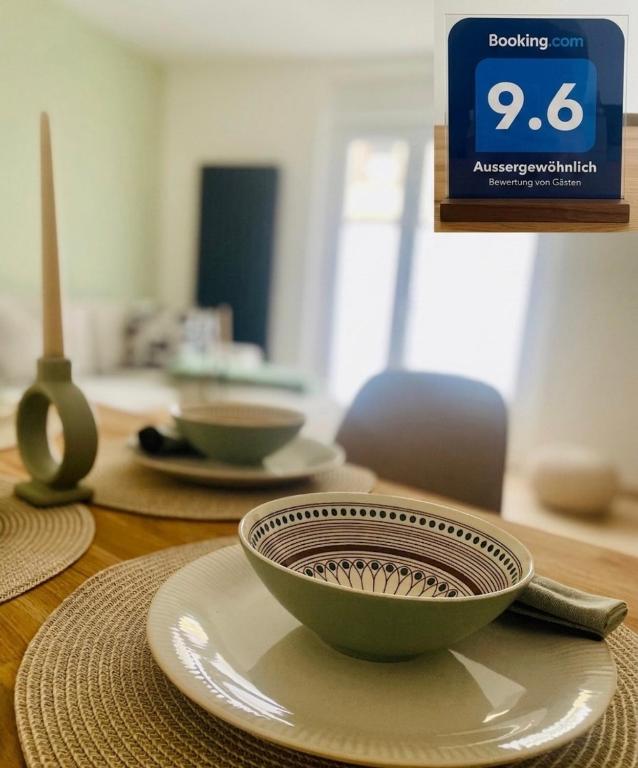 a bowl sitting on a plate on a table at Ferienwohnung auf der Spreeinsel in Spremberg