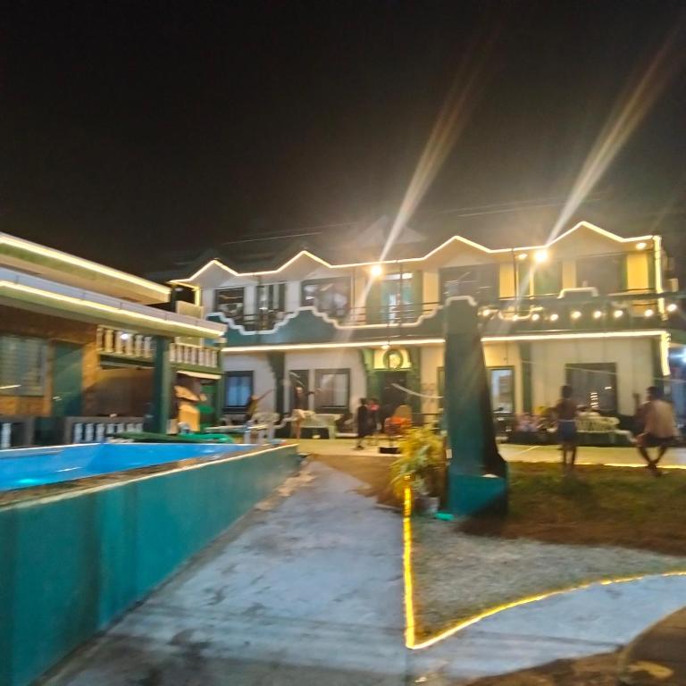 ein großes Haus mit Swimmingpool bei Nacht in der Unterkunft Moonlight Seaside Apartments Liloan Cebu in Catarman