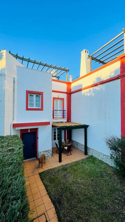 a house with a ping pong table in the yard at Praia Verde Residence in Praia Verde