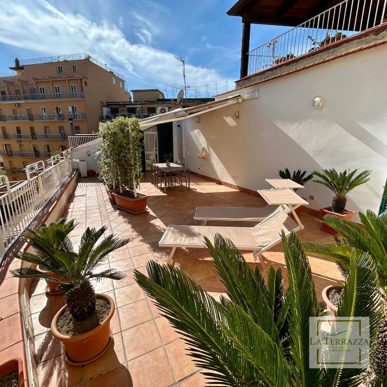 a balcony with potted plants on a building at La Terrazza in Castellammare di Stabia