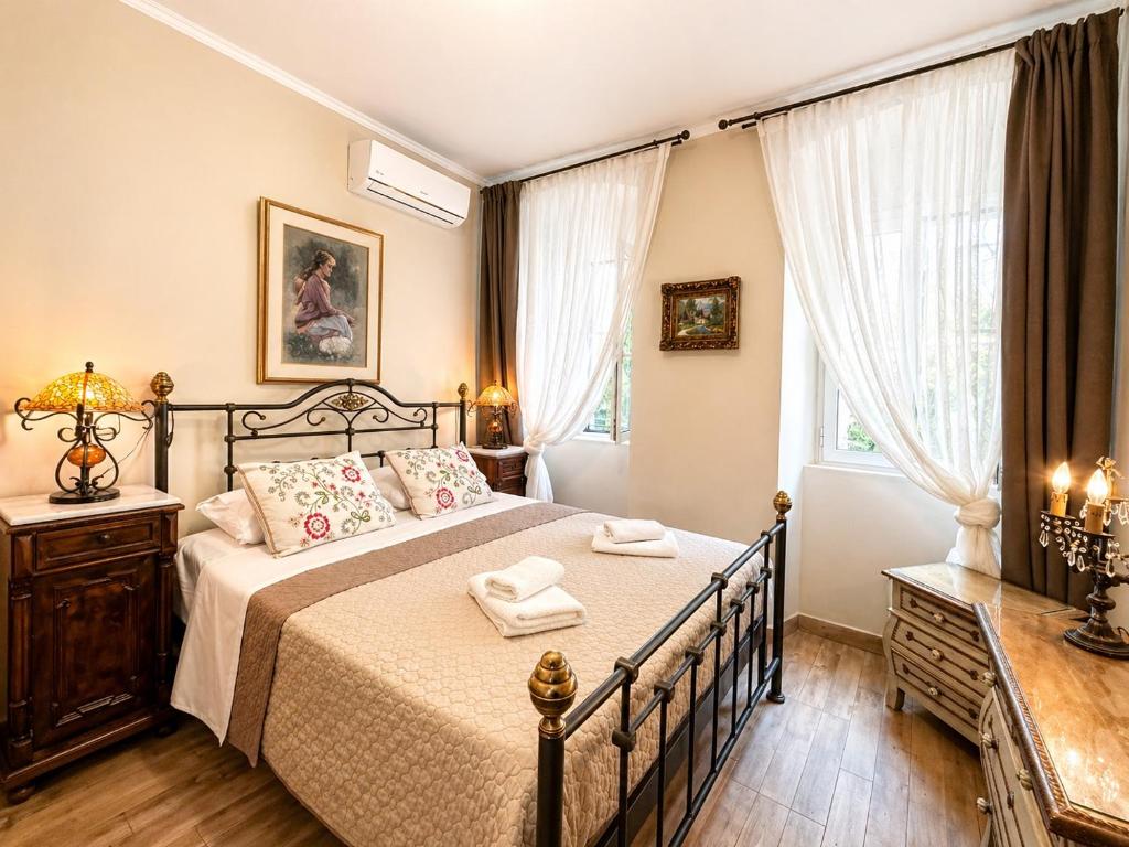 a bedroom with a bed with two towels on it at Dion and Eva's OldTown Apartment in Corfu