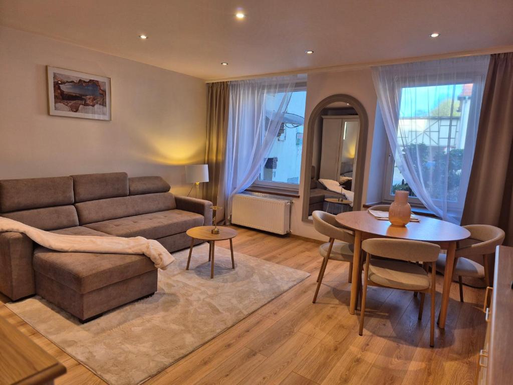a living room with a couch and a table at DORMAR I Apartament in Wałbrzych