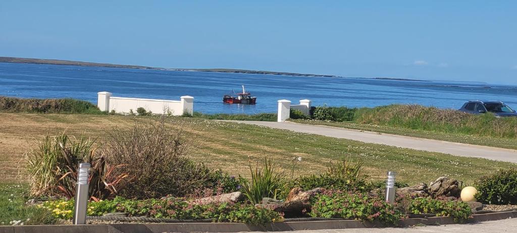 a view of the water with a boat in the water at Atlantic Way Suites Doonbeg Co Clare in Doonbeg