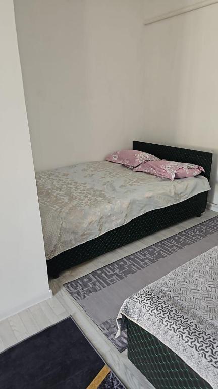 a bedroom with a bed in a room with a mirror at Tumar in Saty