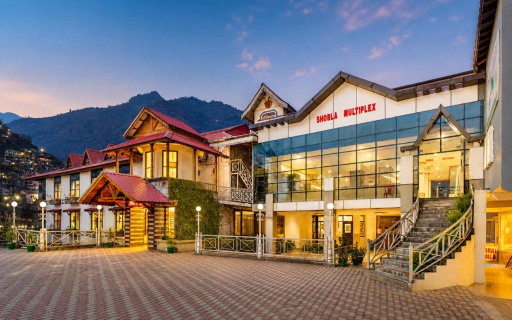 a large building with a staircase in front of it at Shobla Royale in Kulu
