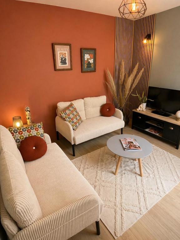 a living room with a couch and a table at Casa Terracotta in Saint-Aignan