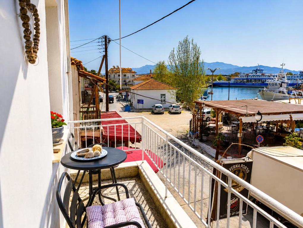 a balcony with a table and a view of a street at Sophia House in Keramoti