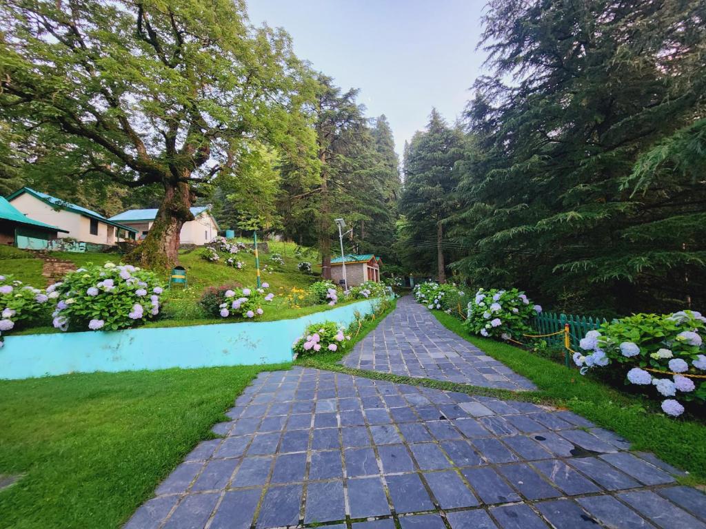 a cobblestone path in a garden with flowers at The Smarthill Sanctuary in Dalhousie