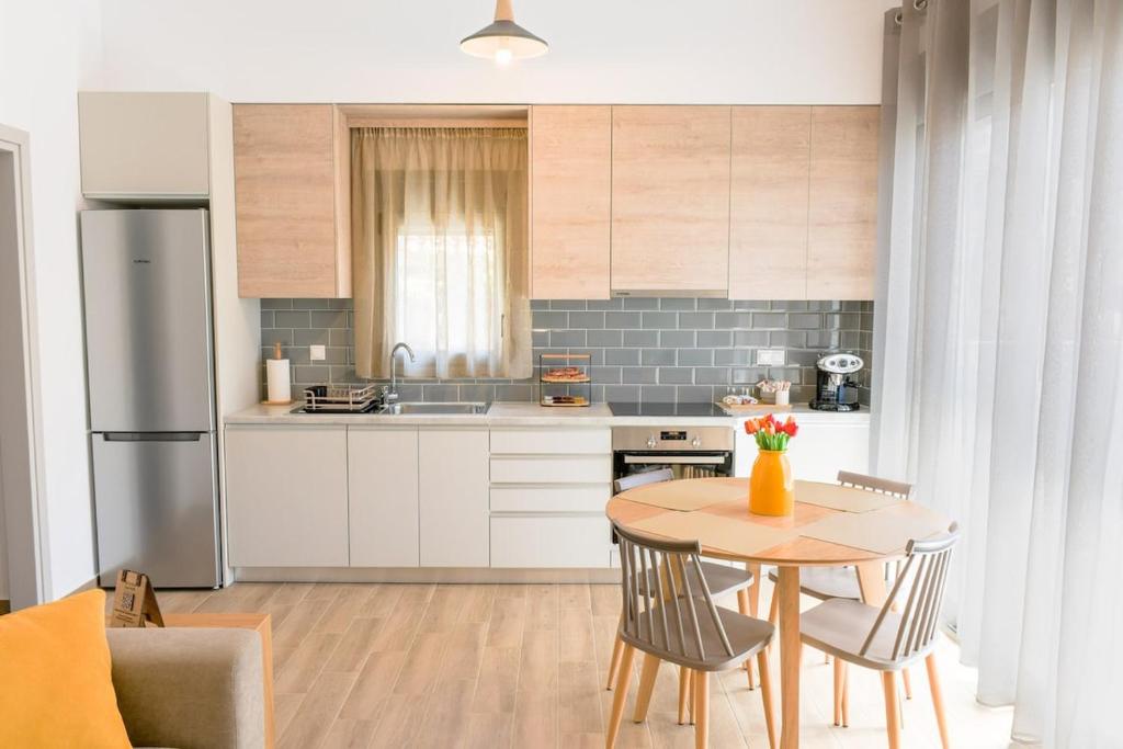 a kitchen with a table and chairs in a kitchen at My Gytheio Apartment in Gythio