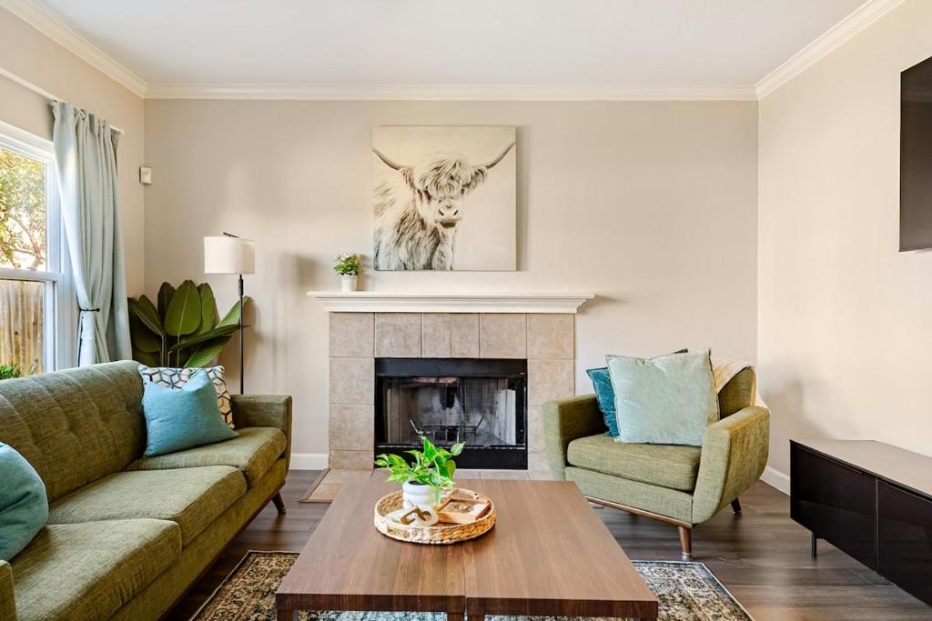 a living room with a couch and a fireplace at Prospect Haus Stone Oak in San Antonio