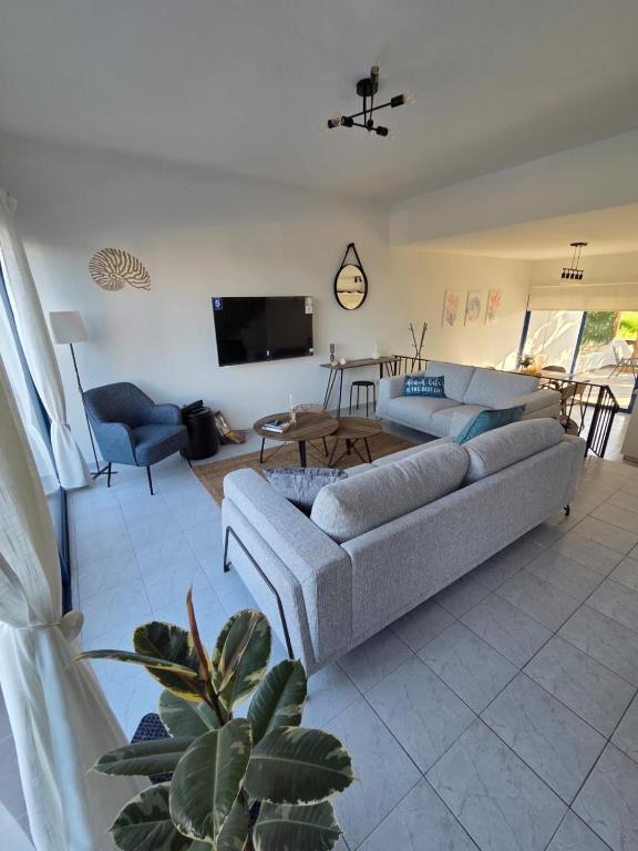 a living room with a couch and a table at KOHILI Seaside Residence in Polis Chrysochous