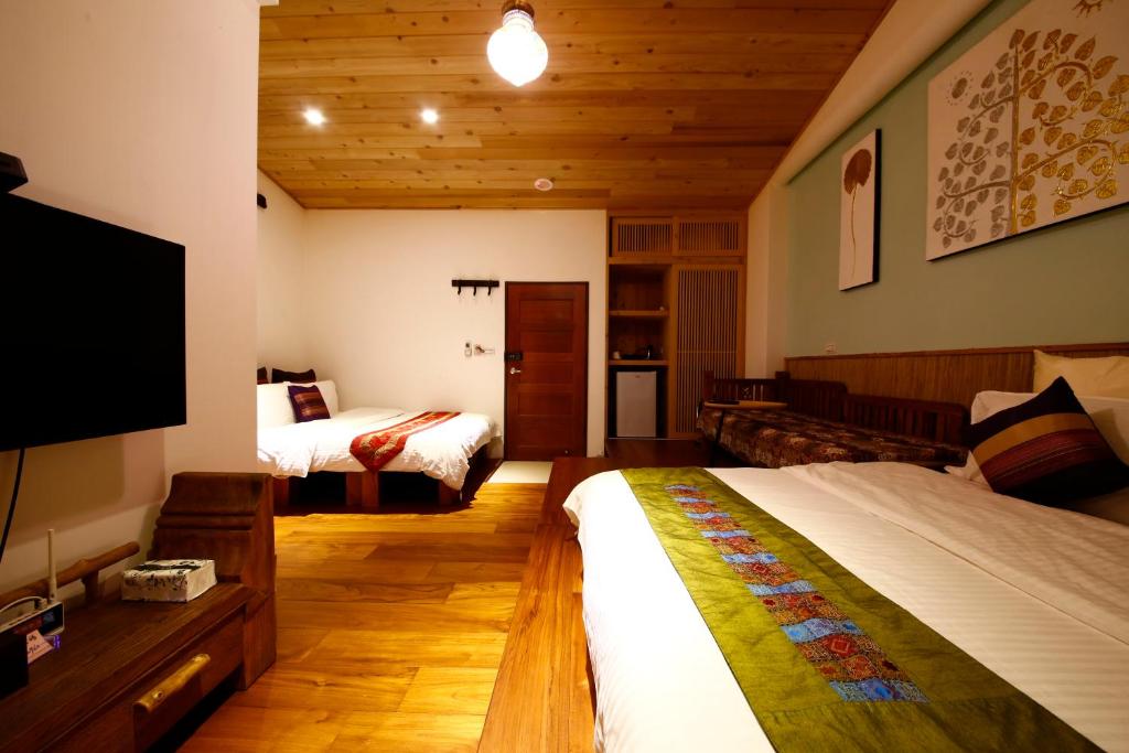 Postel nebo postele na pokoji v ubytování Tang Chao B&B