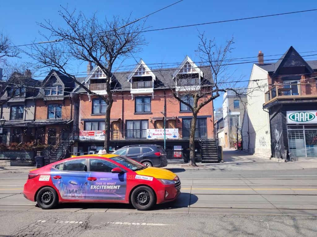 a car parked on the side of a street at Cabbagetown Inn in Toronto