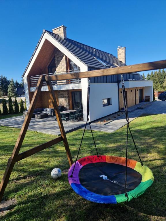 a trampoline in the yard of a house at Villa OLIVIA Ferienwohnung Misdroy Insel Ostsee in Wicko