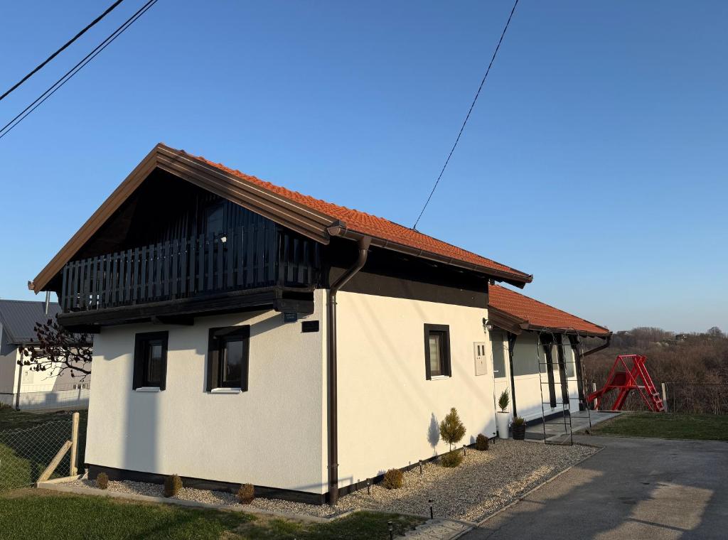 a small white building with a brown roof at Kuća za odmor Hrešć in Donji Koncovčak