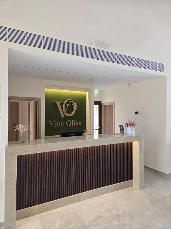 a hotel lobby with a veritas office sign on the counter at Vina Oliva Hotel in Pissouri