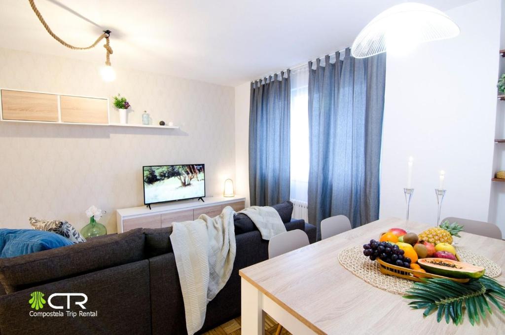 a living room with a couch and a table with fruit on it at Spacious & Central Apartament in Santiago de Compostela
