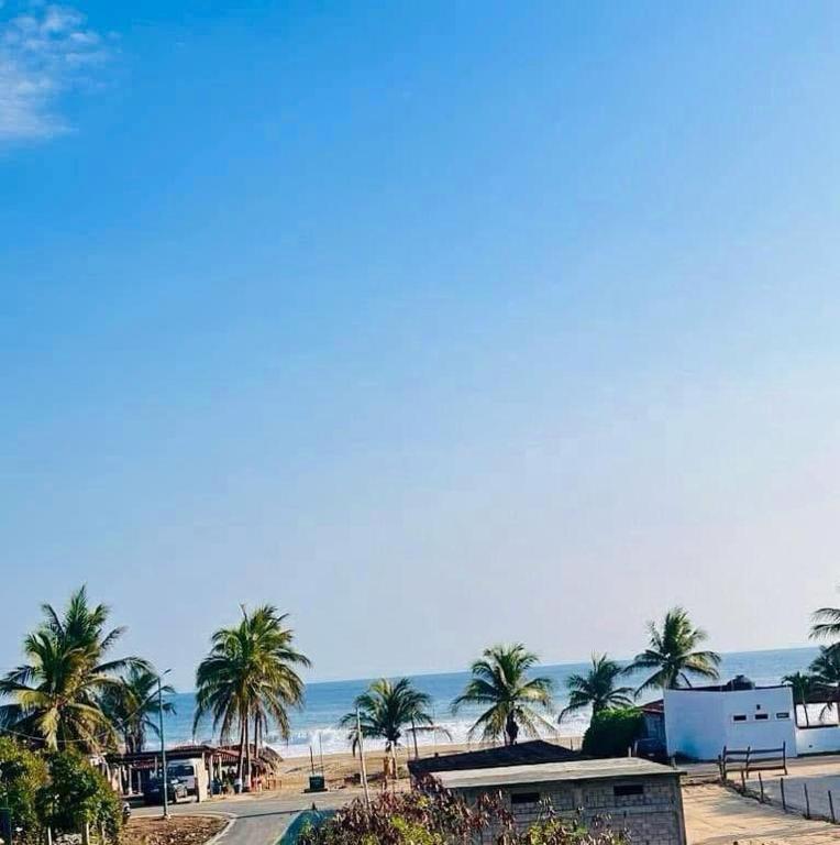 a view of a beach with palm trees and the ocean at Casa De Playa in Agua de Correa