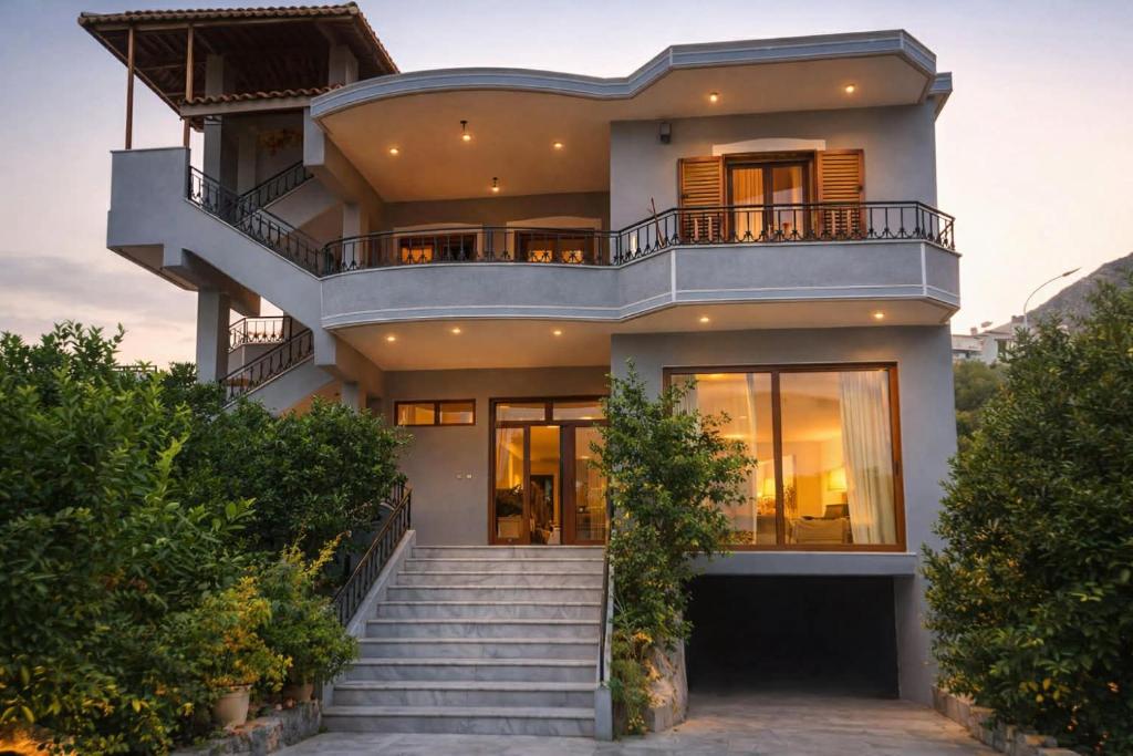 a house with a staircase in front of it at Villa Ekluxe in Delvinë