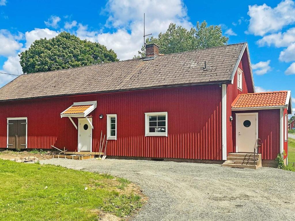 a red barn with a red roof at 4 person holiday home in ANEBY-By Traum in Aneby