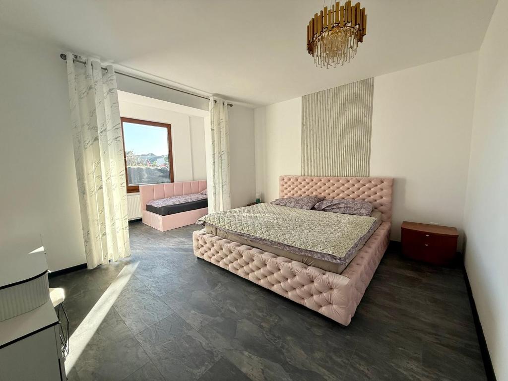 a bedroom with a pink bed and a window at Self-Check- New Home in Levice