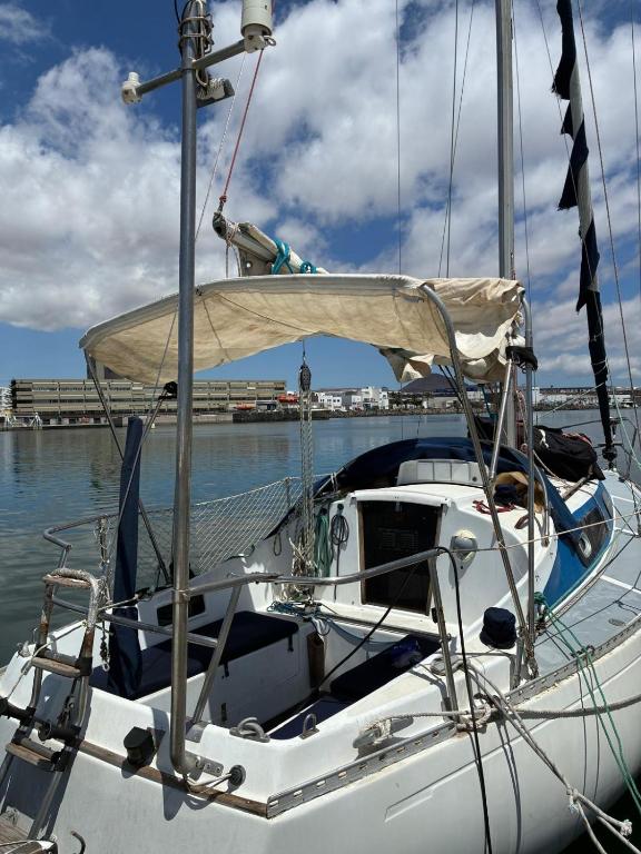a white boat is docked in the water at Ulia in Arrecife