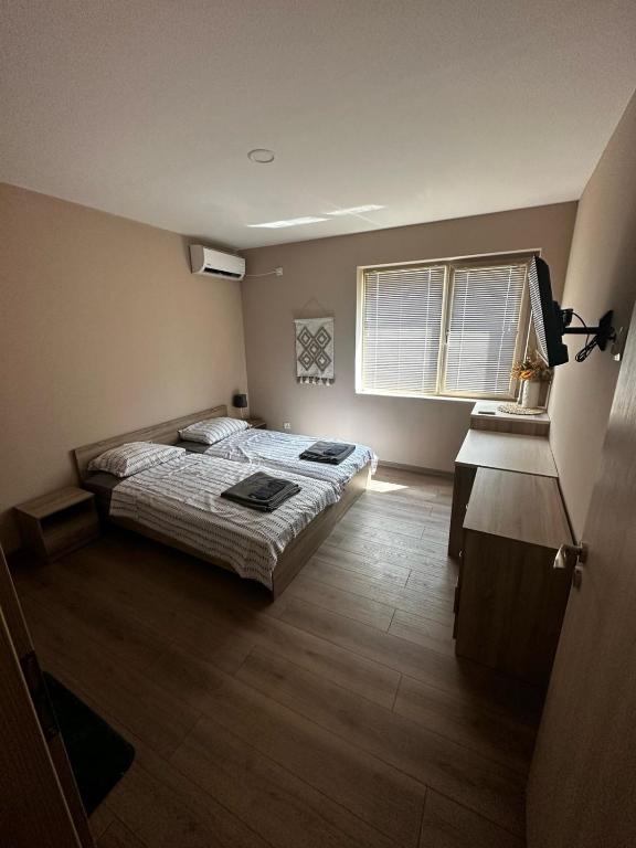 a bedroom with two beds and a window at Irene in Pawlikeni