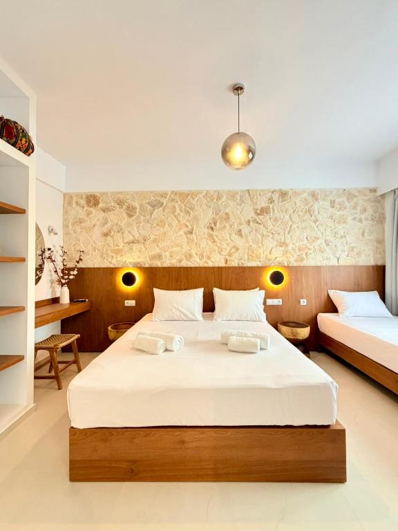 a bedroom with a large white bed in a room at Kapetánissa Concept Studios in Stalís