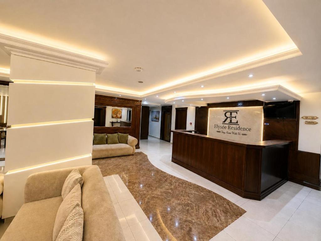 a living room with a couch and a flat screen tv at Elysee Residence in Beirut
