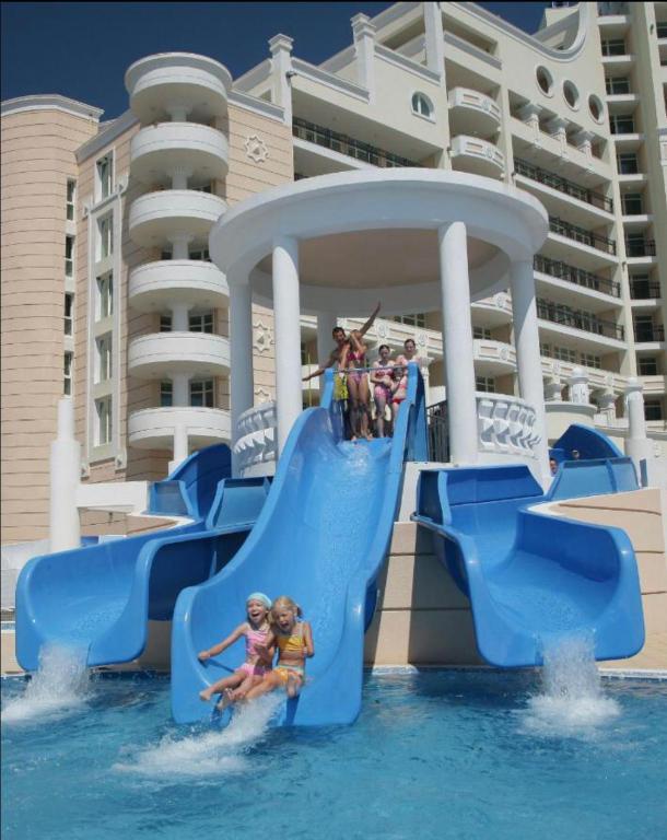 a group of children on a water slide on a cruise ship at Sunset Resort Apartament C3 - 22 in Pomorie