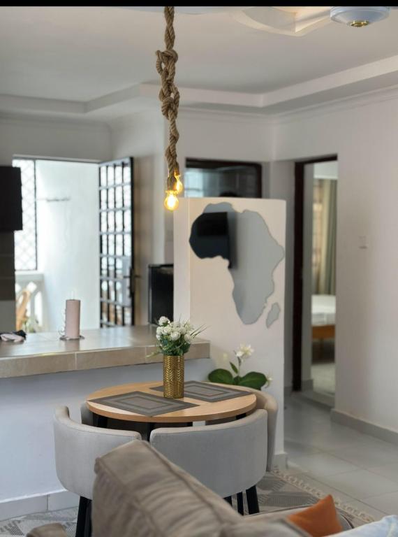 a living room with a table and chairs at Imani staycations Diani in Diani Beach