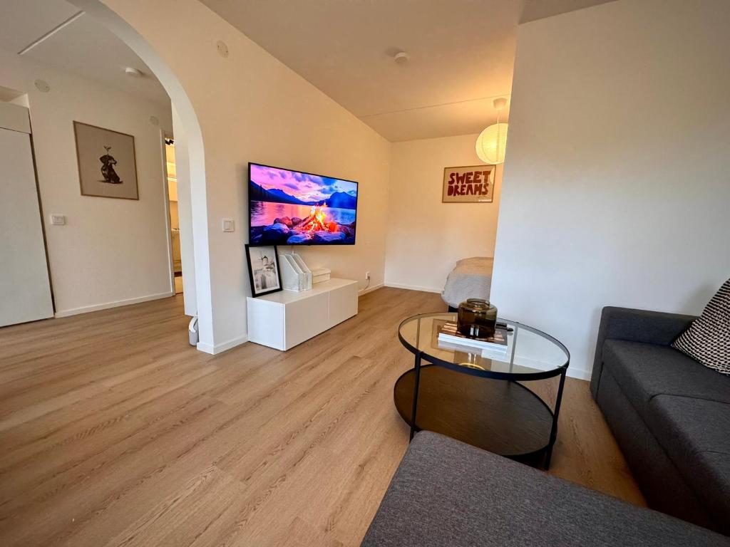 a living room with a couch and a table at Falkenbergsvägen 1C, Ullared in Ullared