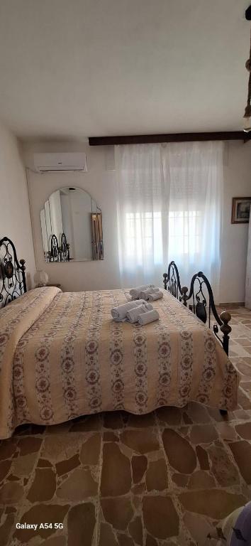 a bedroom with a large bed with a large mirror at B&B Sa Rocca Manna in Laerru