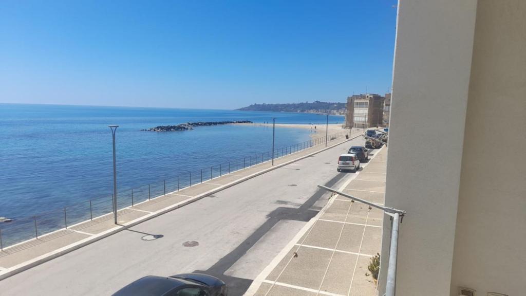 a view of a street and the ocean from a building at Borgo marino litorale salus in Sciacca