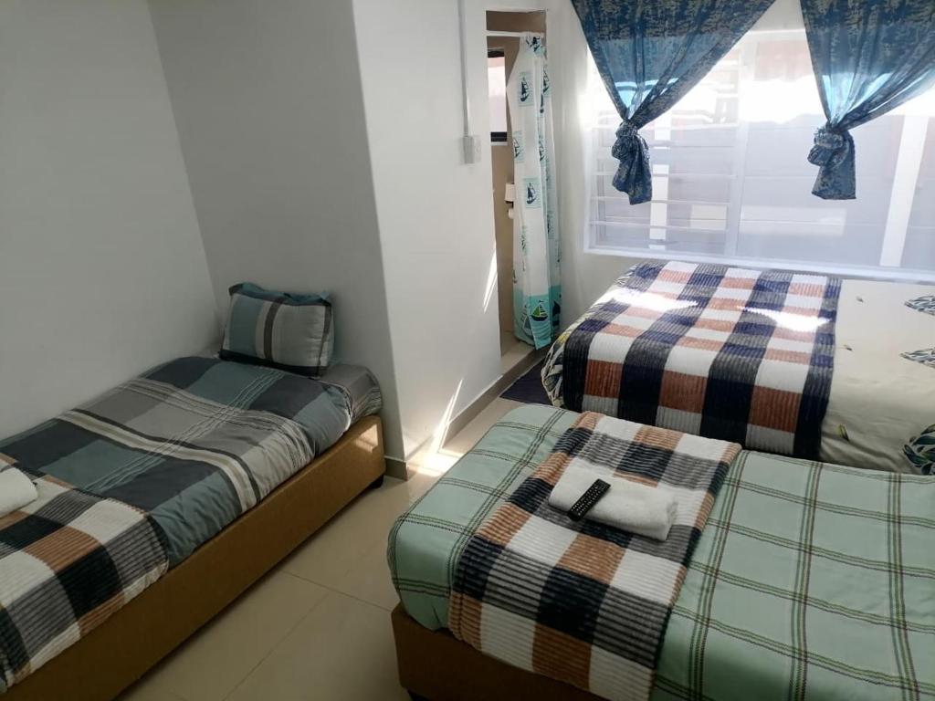 a bedroom with two beds and a window at 48 the trout lodge in Goodwood