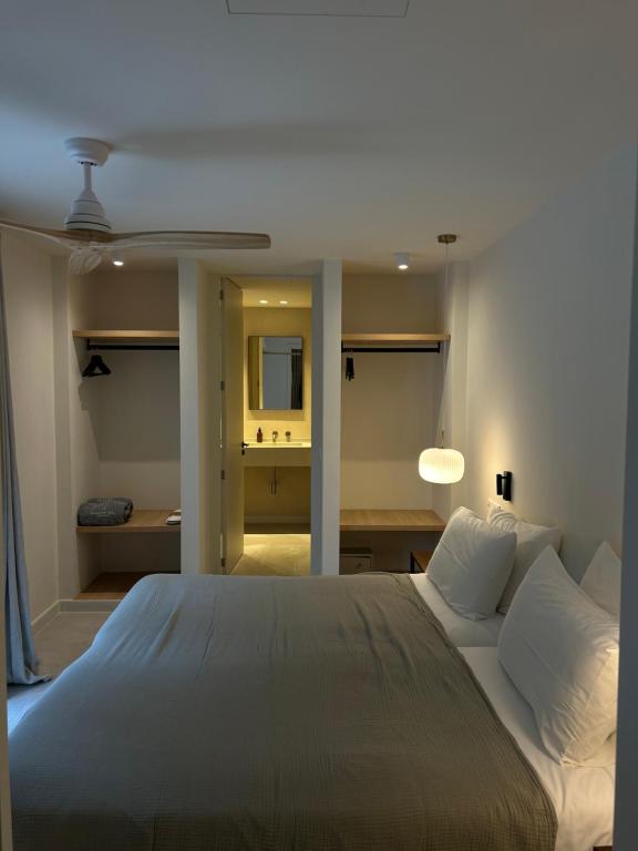 a bedroom with a large bed and a bathroom at Serena Sol Apartments - Adults Only - Over 12 in Cala Serena