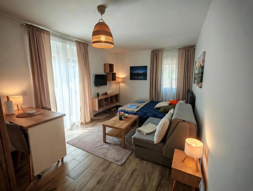 a living room with a couch and a bed at Studio Vidik Sofija in Divčibare