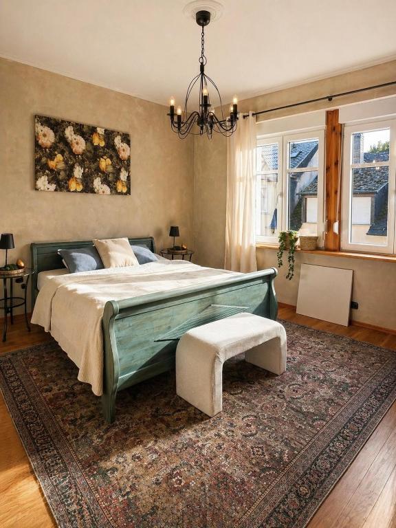 a bedroom with a large bed and a rug at Das Mosel Ferienhaus in Zell an der Mosel