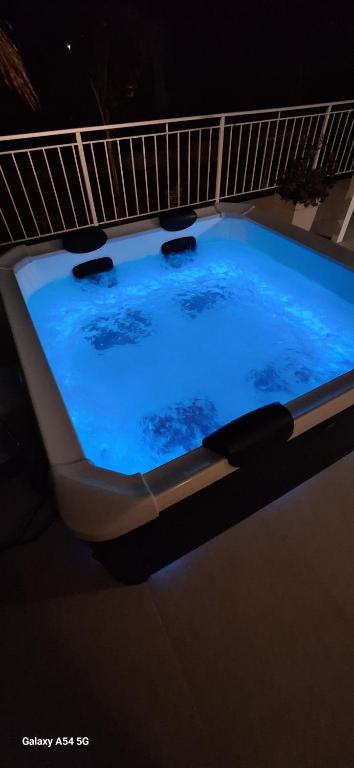 a large blue hot tub in a room at Cozy White House - Near Beach Private Jacuzzi in Ksamil