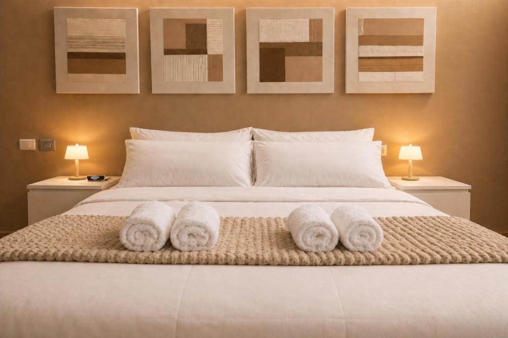 a bedroom with a bed with towels on it at Easy Loft Milano in Crescenzago