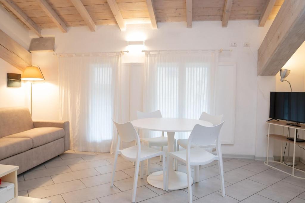 a living room with a table and chairs and a couch at Urban Studio Apartment in Brescia