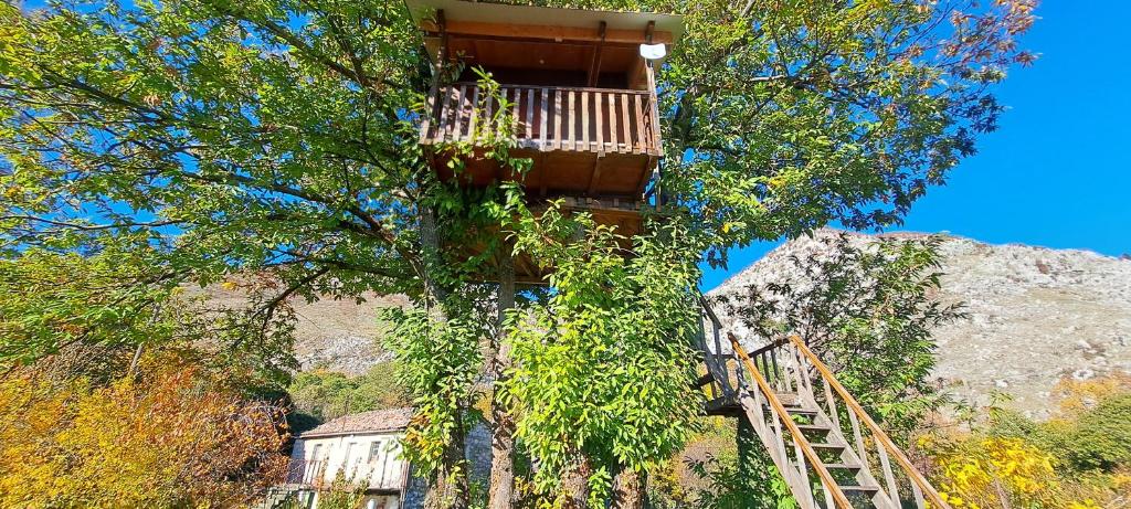 a tree house with a balcony on top of it at TreeHouse in Bar