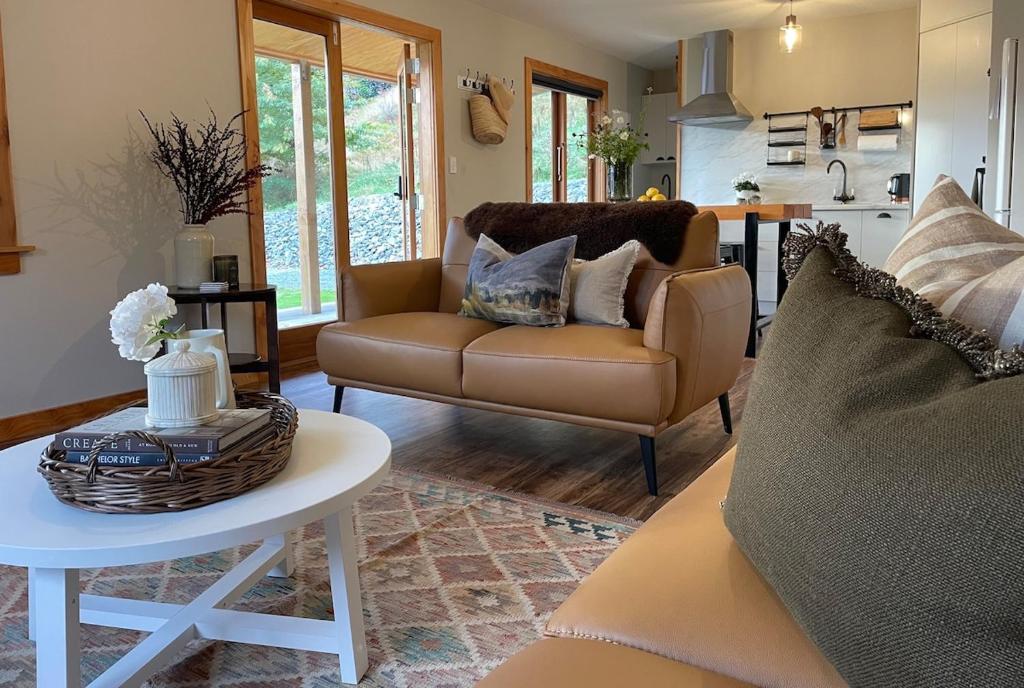 a living room with a couch and a table at 1860 Lawrence Cottage in Lawrence