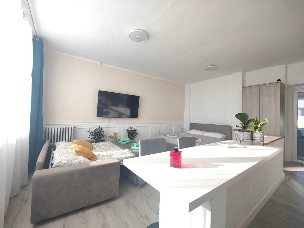a living room with a couch and a table at Mini Loft con terrazza vista Alpi in Vinovo