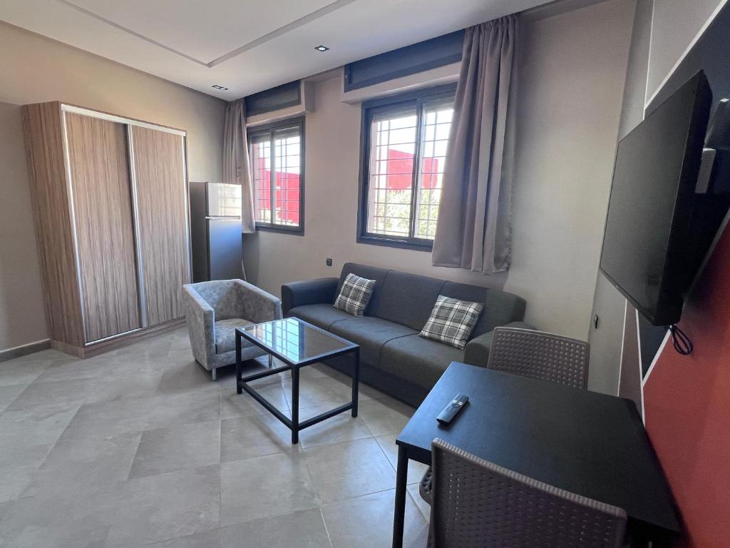 a living room with a couch and a table at Appartement No 2 à Tamraght in Tamraght Ouzdar