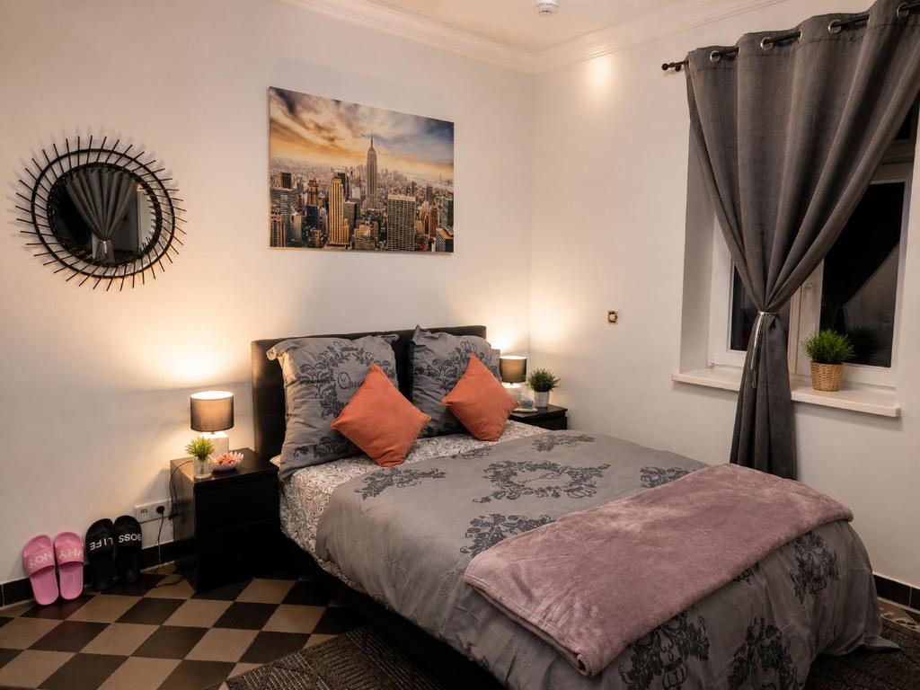 a bedroom with a bed with pillows and a mirror at Peaceful & Cozy Apartment in Dresden