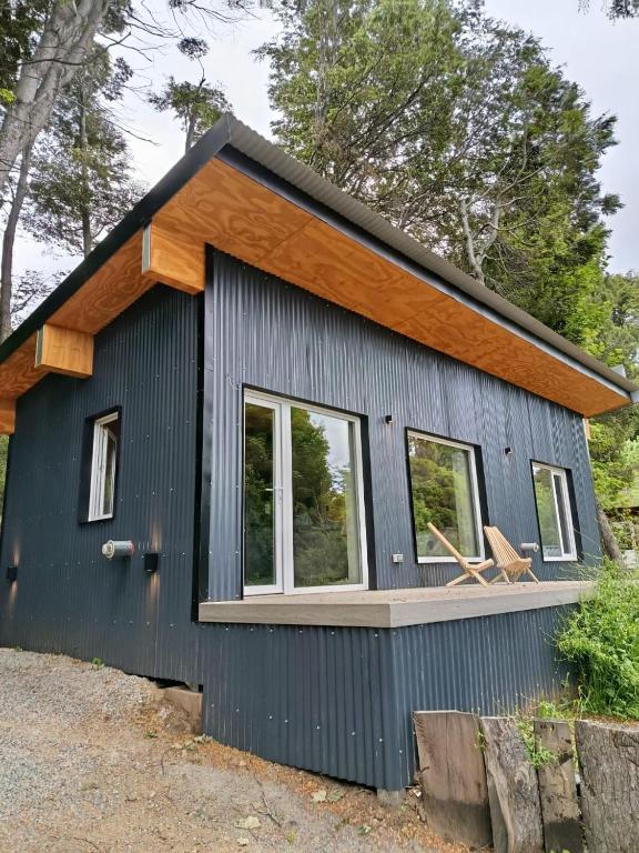 a tiny house with a porch and windows at Kattyjaus in San Carlos de Bariloche